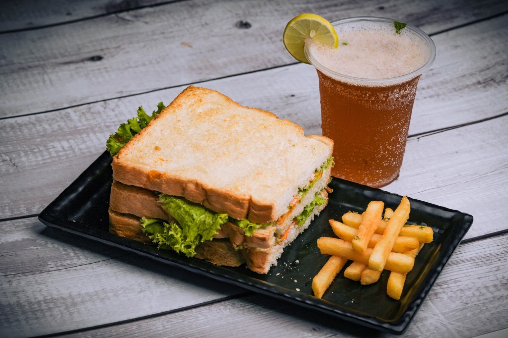 Veg club sandwich with fries and iced tea