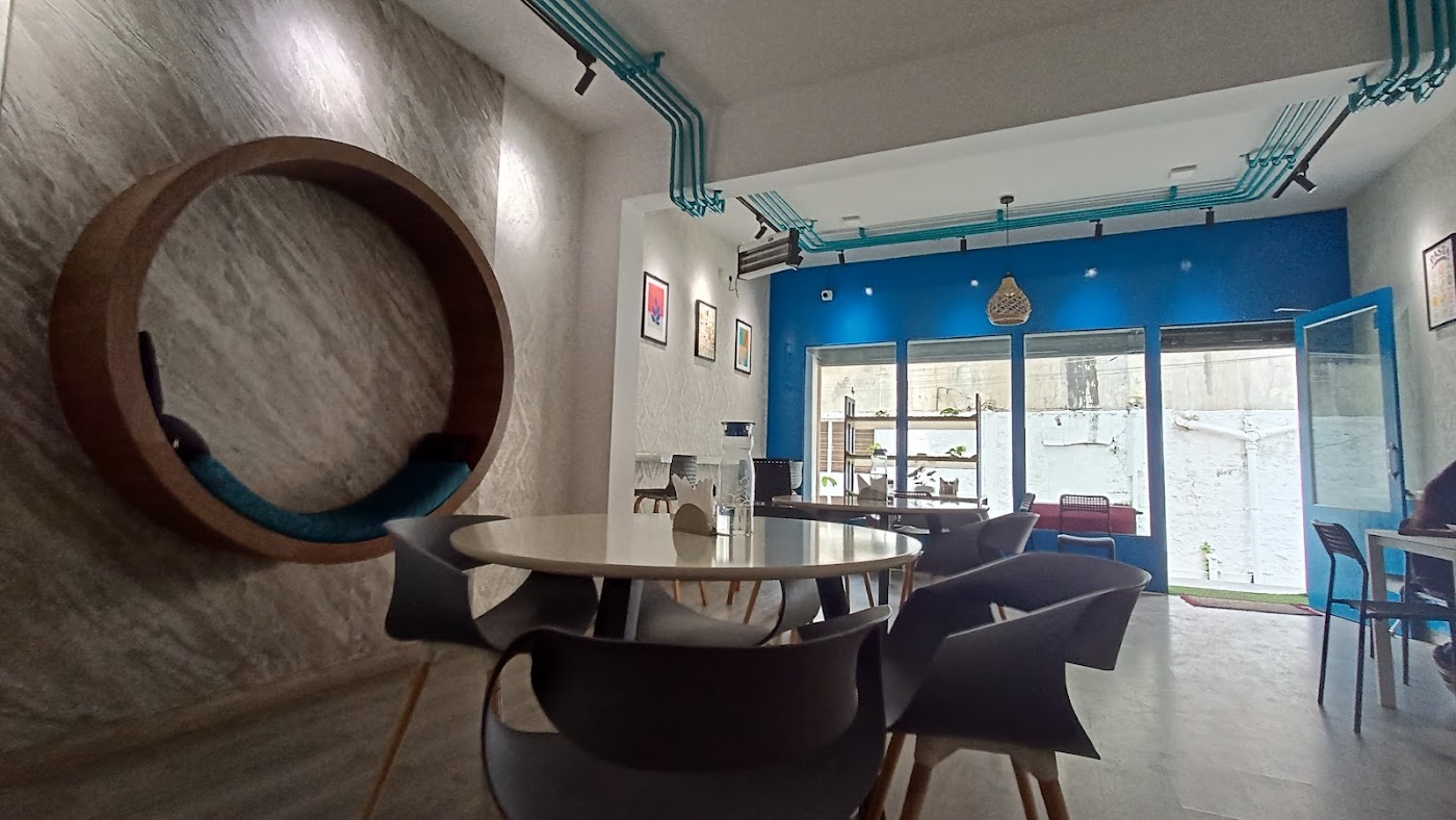 Dining room at the K.R. Puram cafe, with the round seat and blue wall